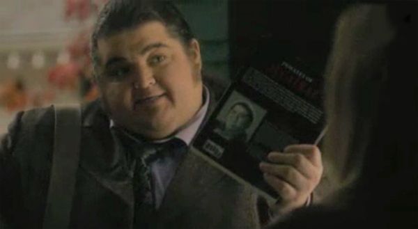 image of Jorge Garcia holding up a book with an author pic of himself from the most recent episode of Alcatraz
