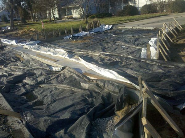 image of my driveway, covered in planks and tarps