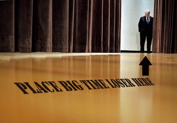 image of Newt Gingrich standing backstage between two big curtains at a campaign event, to which I have added text looking as if it's written on the floor reading 'Place big time loser here' accompanied by an arrow pointing to Gingrich