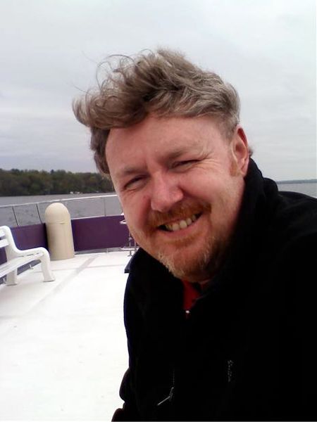 image of Iain on a boat, with windswept hair