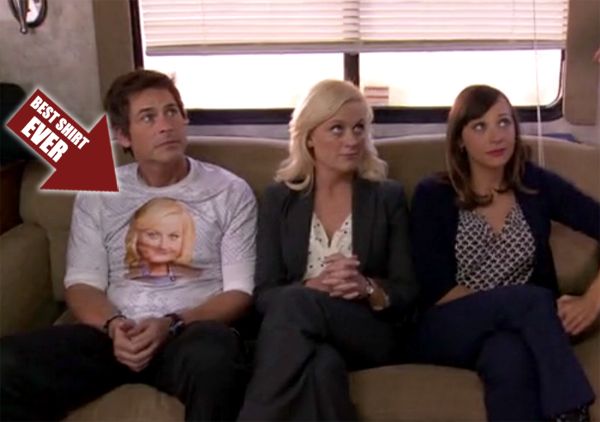 image of Chris Traeger, Leslie Knope, and Ann Perkins on the bus; Chris is wearing a t-shirt with Leslie's face on it, and I have added an arrow pointing to it labeled BEST SHIRT EVER