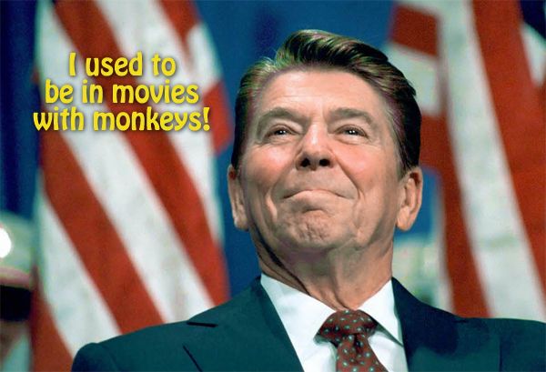 image of Ronald Reagan standing in front of flags grinning proudly, to which I have added text reading 'I used to be in movies with monkeys!'