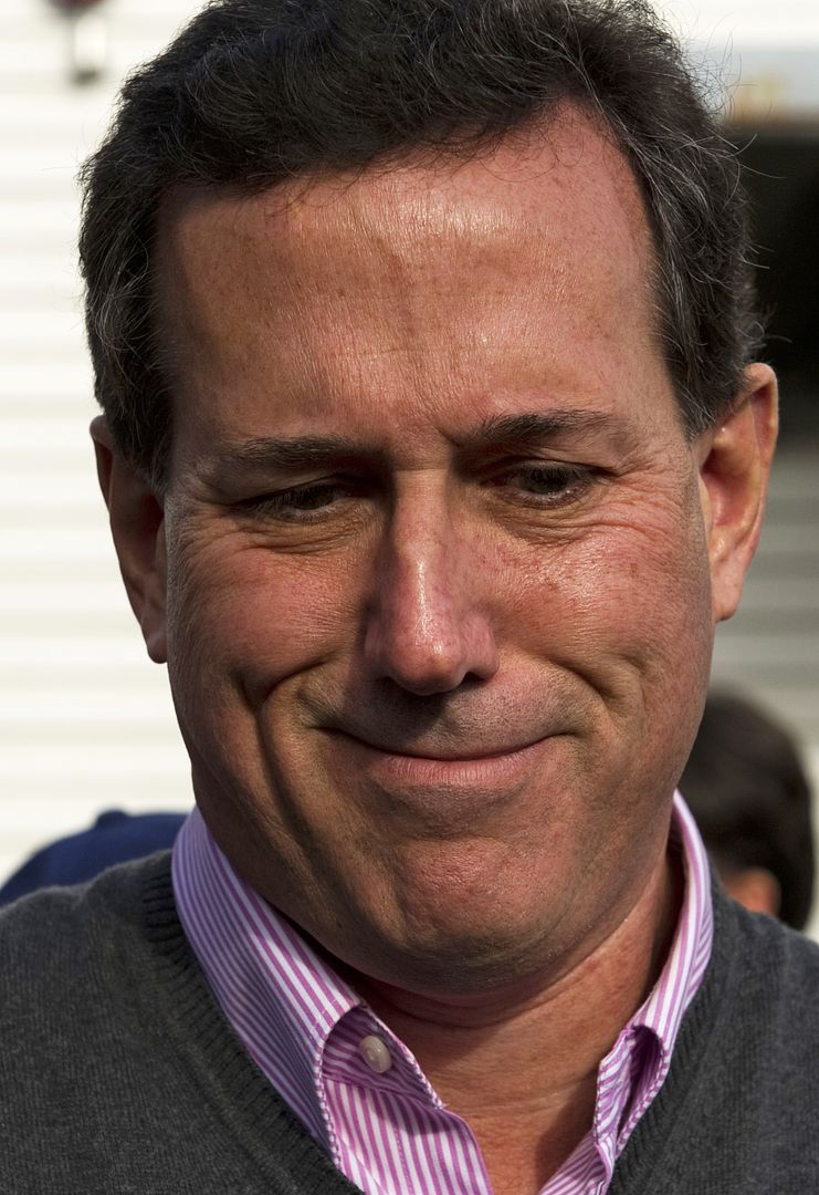 image of Rick Santorum looking down at something and making a face