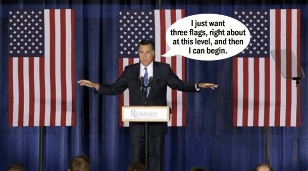 image of Mitt Romney standing at a podium in front of three flags at a campaign event, to which I have added a dialogue bubble reading: 'I just want three flags, right about at this level, and then I can begin.'