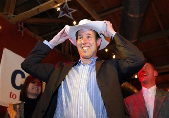 Rick Santorum wearing a cowboy hat and smiling