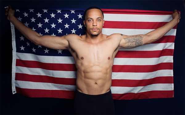 image of a black man holding up a US flag behind him
