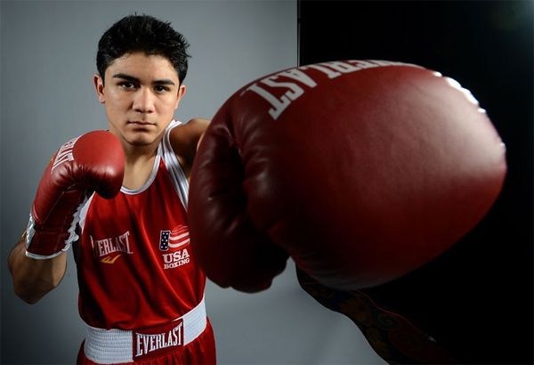 image of a young Latino man wearing boxing gloves