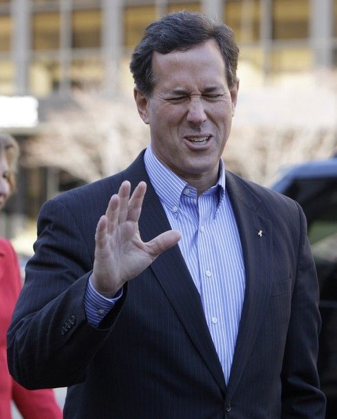 image of Rick Santorum holding up his hand in protest and making a face