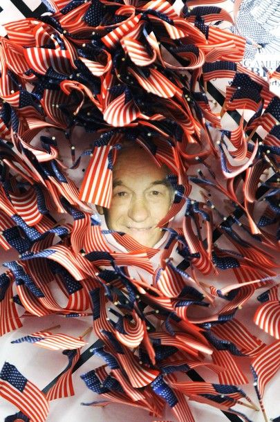 a picture of Ron Paul surrounded by lots of little US flags