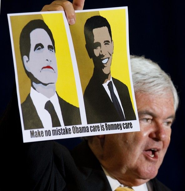 image of Newt Gingrich holding up a sign with cartoony portraits of President Barack Obama and Mitt Romney reading 'Make no mistake Obama care is Romney care'