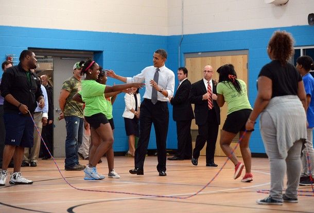image of President Obama surrounded by people, including two very excited young women who were double-dutching