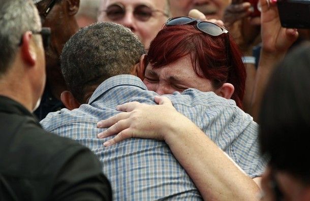image of President Barack Obama hugging a white woman who is crying, in a crowd at a campaign stop