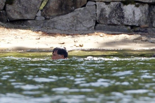 image of Mitt Romney swimming with just his head above the water