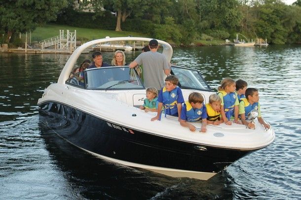 image of Mitt and Ann Romney in their boat with seven children, at least some of whom are their grandchildren, in the boat's bow