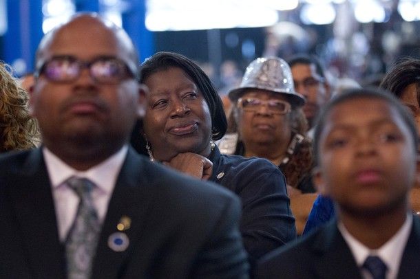 A woman sits in the audience of Romney's NAACP address, looking completely over it