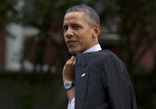 image of President Barack Obama walking with his jacket slung over his shoulder