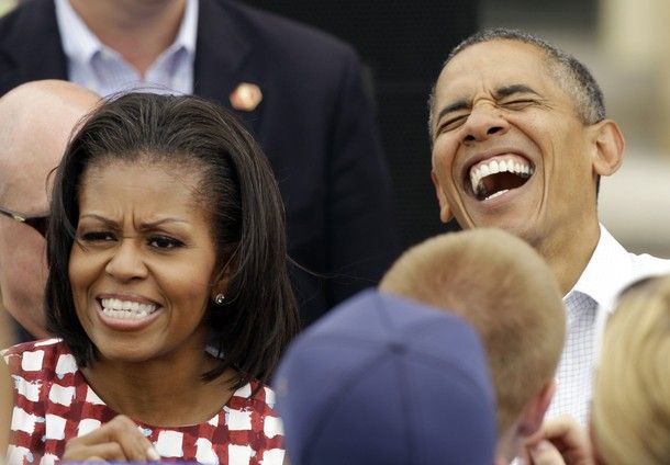image of President Obama laughing with First Lady Obama making a funny expression beside him