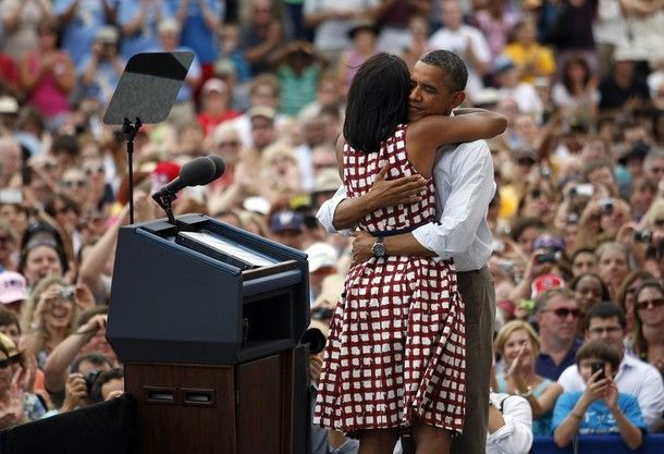 image of the President and First Lady hugging onstage in front of a huge crowd
