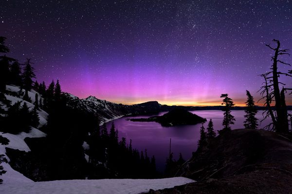 image of brilliant auroral colors in the sky over Crater Lake, Oregon