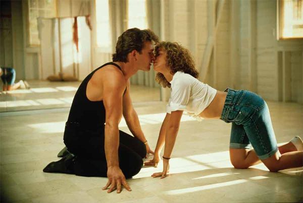 image of Patrick Swayze and Jennifer Grey from Dirty Dancing, in which they are kneeling on the floor and crawling toward each other to kiss.