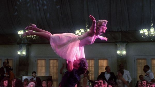 image of Patrick Swayze and Jennifer Grey from Dirty Dancing, in which Swayze is lifting Grey over his head during the finale dance number.