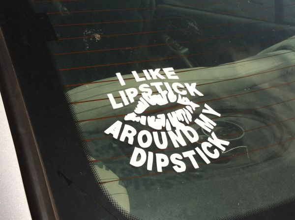 image of a decal in the back window of a car reading 'I like lipstick around my dipstick'