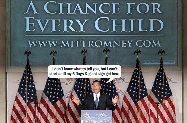 image of Romney standing at a podium at a campaign event, in front of six flags and a giant sign with his website address on it, to which I have added a dialogue bubble reading: 'I don't know what to tell you, but I can't start until my 6 flags & giant sign get here.'