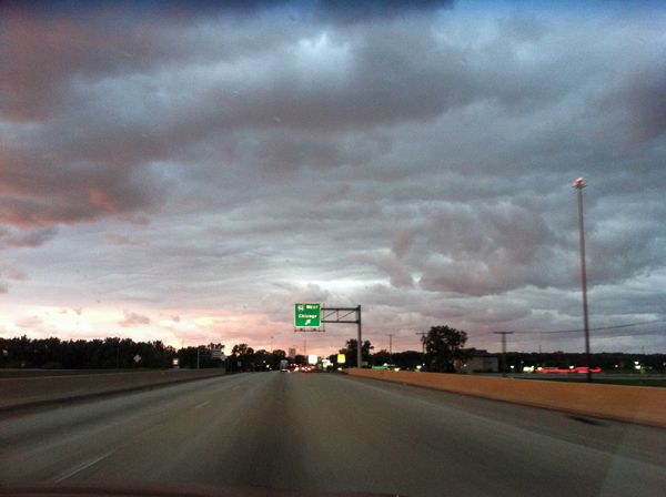 image of the sky above the road ahead, with low-hanging beautiful clouds