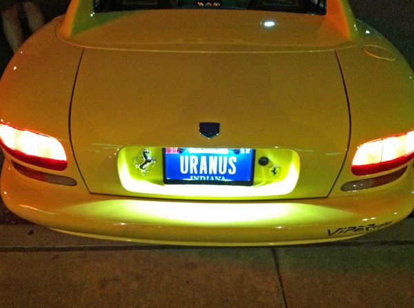 image of the rear of a yellow sports car with a license plate reading URANUS