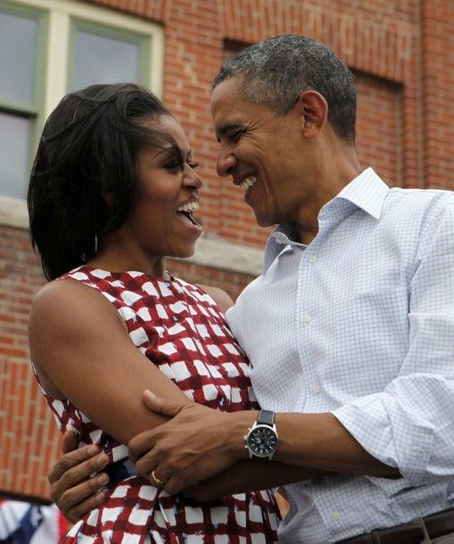 image of the President and First Lady holding each other loosely, looking at each other, and smiling