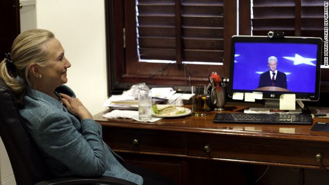 image of Hillary Clinton watching the speech on a small TV in an office