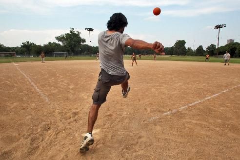 image of a person kicking a ball in a kickball game