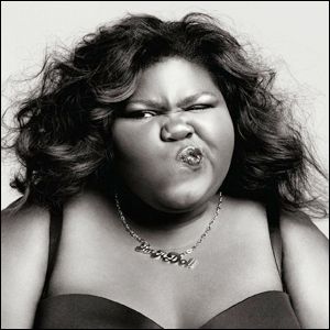 black and white image of Gabby Sidibe, a fat black woman, scrunching up her face and looking tough as hell