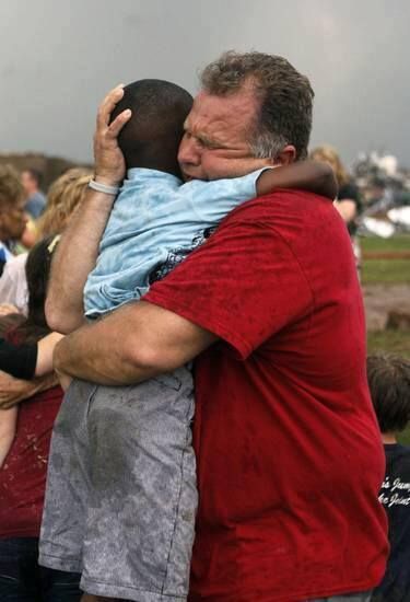 image of a middle-aged white man hugging a young black boy