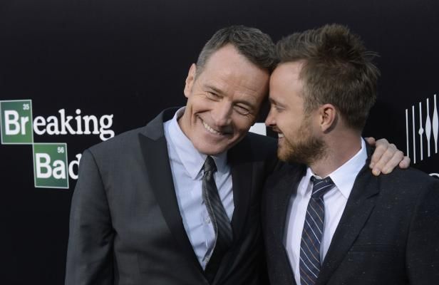 image of Bryan Cranston (Walt) and Aaron Paul (Jesse) posing for a picture together and smiling at the premiere of the final season of Breaking Bad