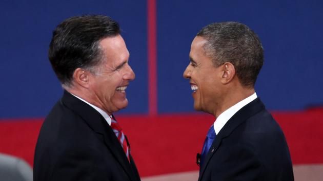image from a debate of Mitt Romney and President Obama greeting each other with terse smiles