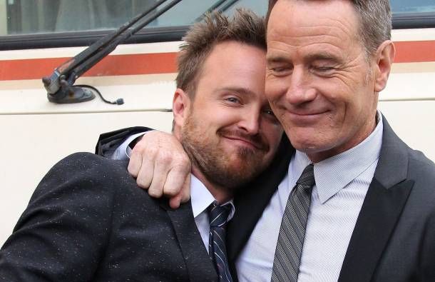 image of actors Bryan Cranston and Aaron Paul standing in front of the RV and hugging each other at the last season premiere of Breaking Bad