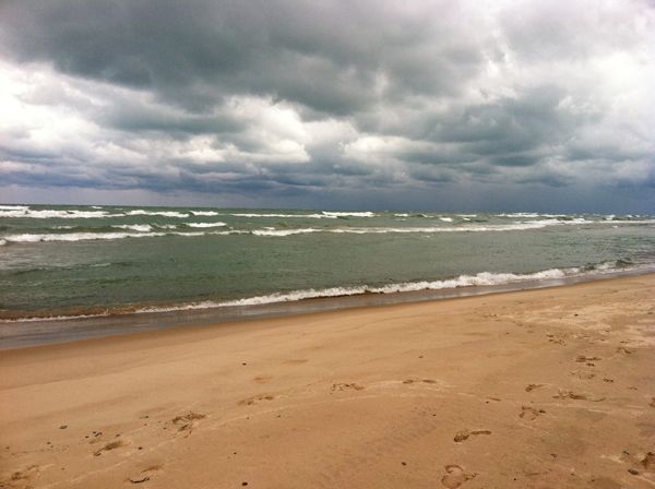 image of the beach to the east with tumultuous water and stormy skies