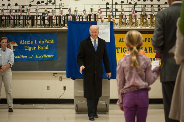 image of Vice President Joe Biden walking away from a voting booth, grinning broadly