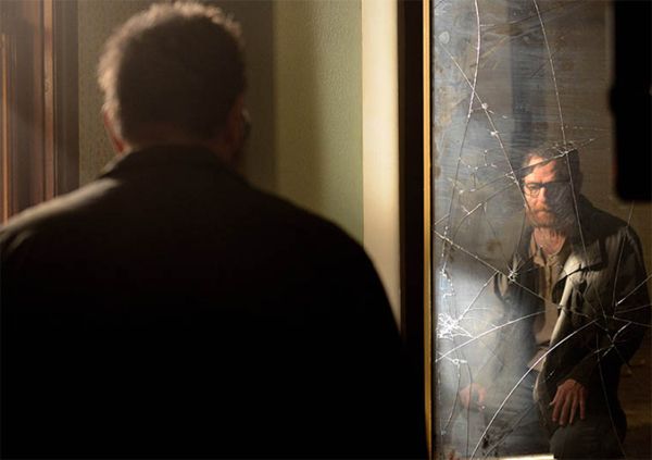 image of Walt with a beard looking at himself in a cracked mirror