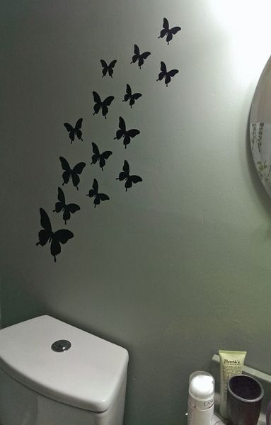image of black butterfly decals on the wall in the bathroom