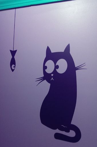 image of teal trim with violet decal of dangling fish and cat looking at dangling fish