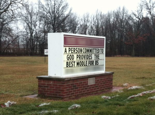 image of a church sign reading: 'A person committed to god provides the best modle [sic] for us'