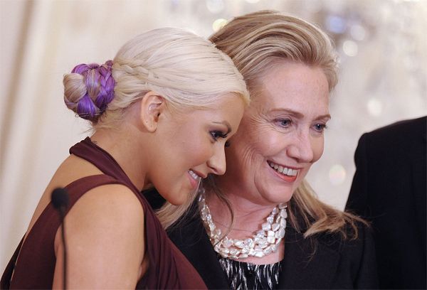 image of singer Christina Aguilera and Secretary of State Hillary Clinton posing together at an event