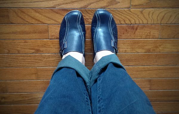 image of my lower legs and feet; I am wearing dark blue denim jeans and dark blue clogs
