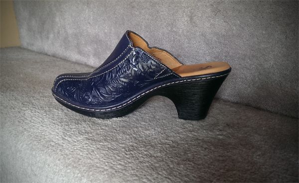 image of blue heeled clog from the side, showing flower detail
