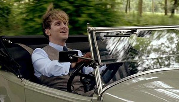 image of Matthew driving his car, smiling