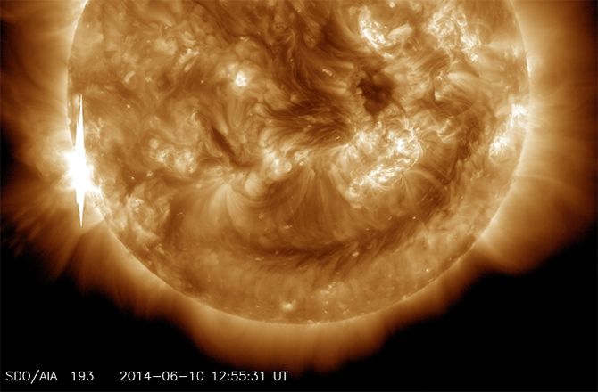 image of a solar flare, showing the sun, the flare on its surface, and a ring of electromagnetic radiation