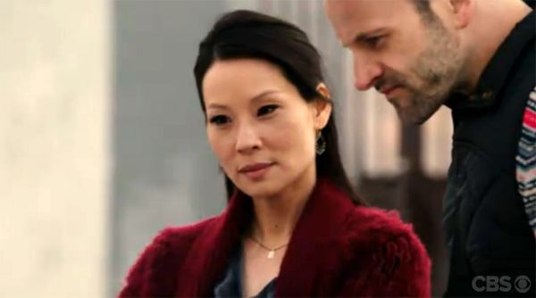 image of Lucy Liu as Joan Watson and Jonny Lee Miller as Sherlock Holmes gazing at something together on a rooftop