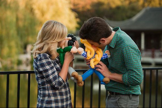 image of Leslie (Amy Poehler) and Ben (Adam Scott) kissing balloon versions of one another on a bridge in a park